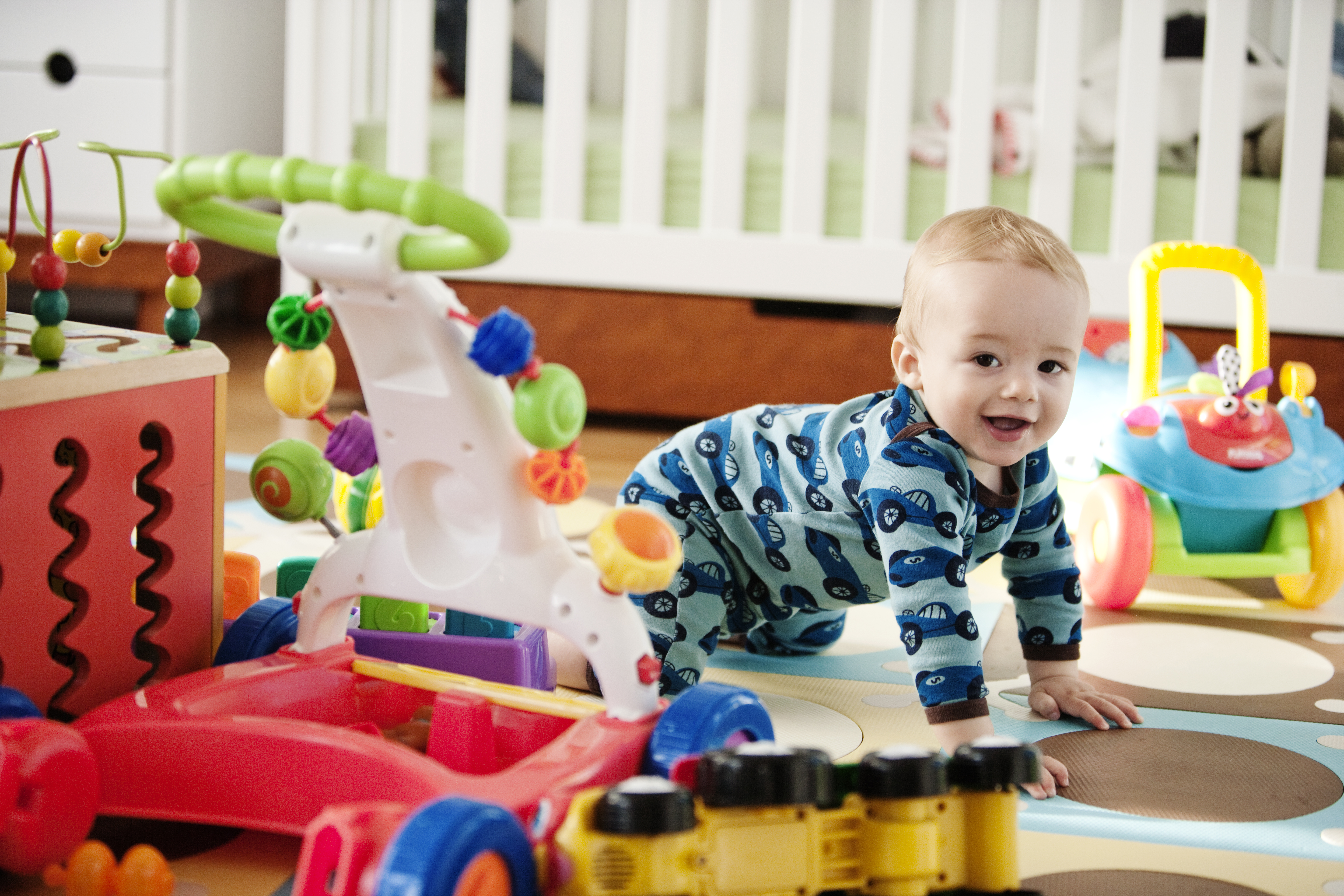 Baby crawling and smiling, toys, crib