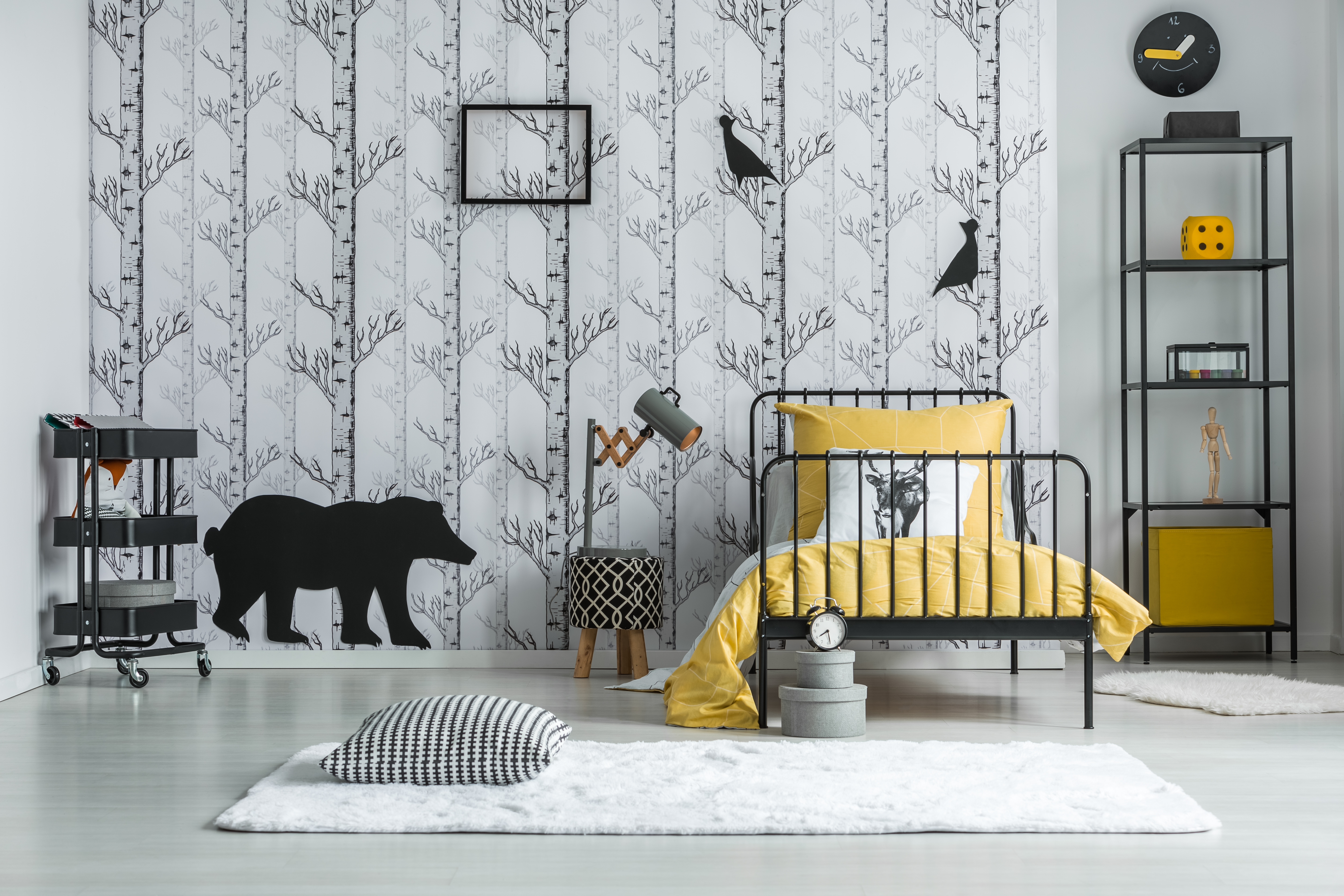 Black and white pillow with houndstooth pattern placed on the carpet in kid's room